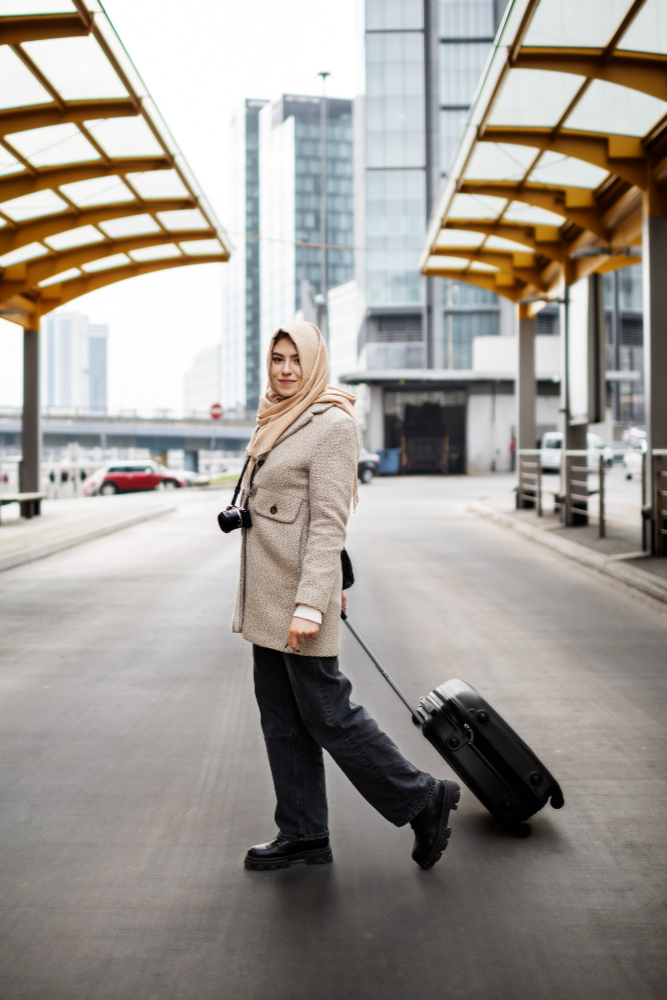 Traveller with a suitcase at a Dubai transit station